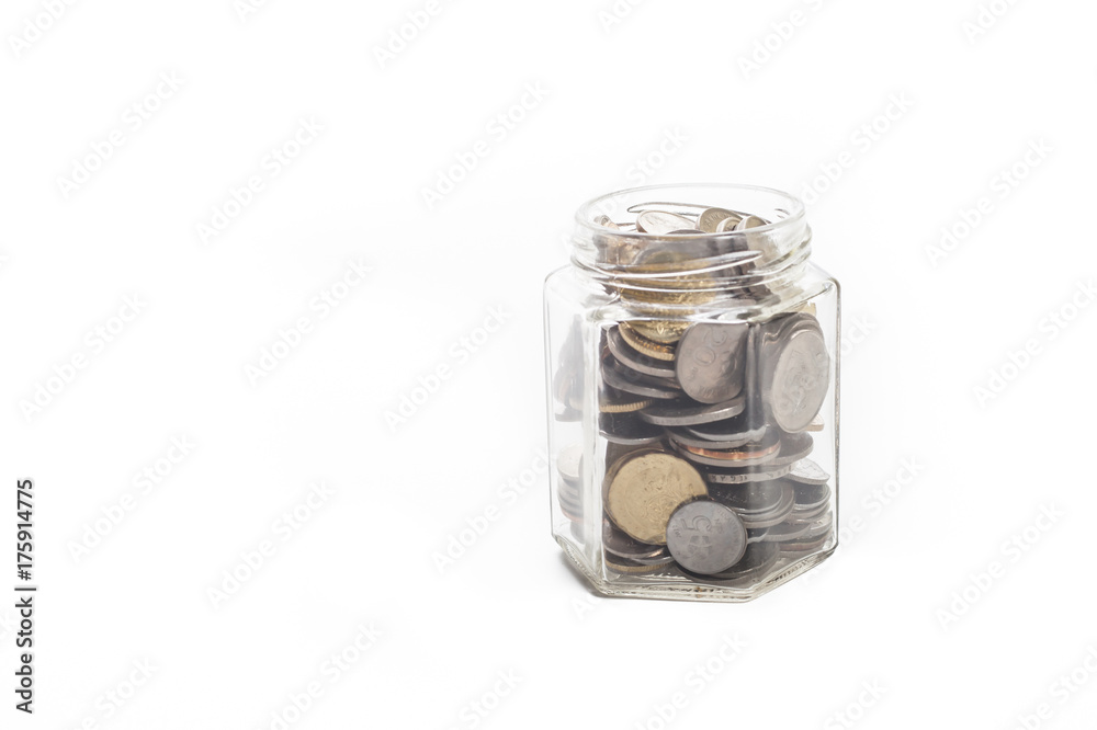 coins in a money jar over white background coins in a money jar over white background