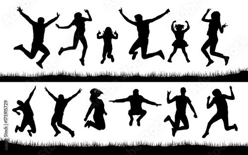 Silhouette of people jumping on the grass