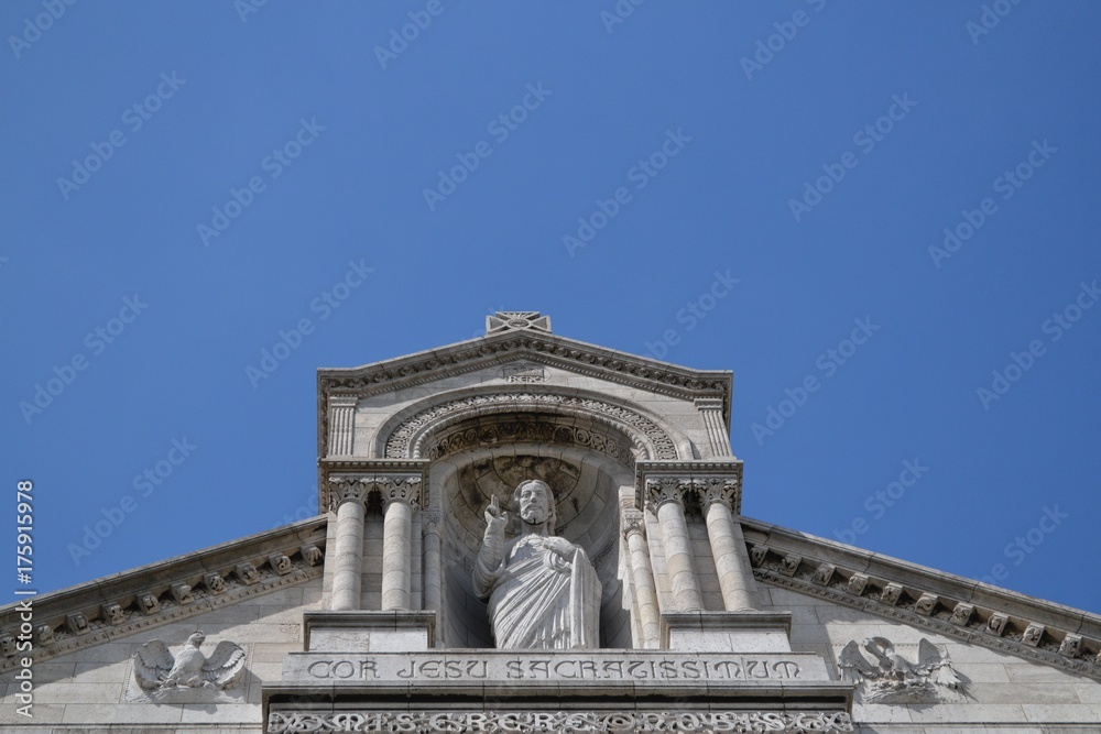 Majestic statue of Jesus blessing, French architectural detail of Sacred Heart Basilica, on Montmartre, in Paris Majestic statue of Jesus blessing, French architectural detail of Sacred Heart Basilica, on Montmartre, in Paris