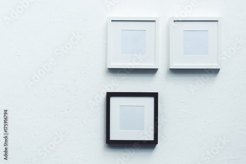 empty photo frames hanging on wall