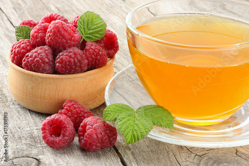 healthy food. raspberry with tea on old wooden background