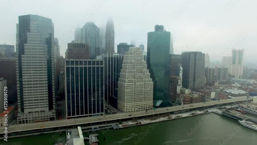 Aerial shot of Brooklyn bridge and boat floating by Hudson river with view of Manhattan on background Aerial shot of Brooklyn bridge and boat floating by Hudson river with view of Manhattan on background