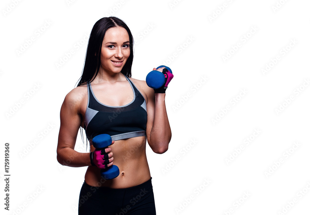 Beautiful young woman do exercises with dumbbells in studio. Sporty athletic girl lifting up weights against white background. Beautiful young woman do exercises with dumbbells in studio. Sporty athletic girl lifting up weights against white background.