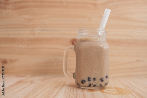 Jar glass Ice milk tea and bubble , Ice milk tea on the wood floor and wood background 