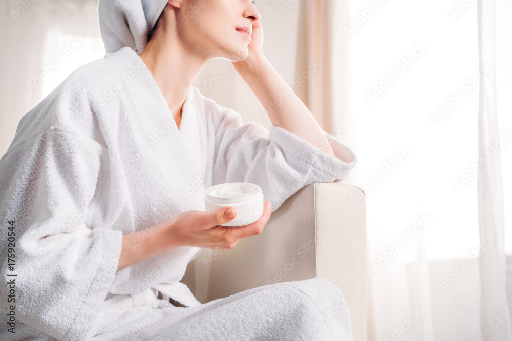 woman holding jar of cream woman holding jar of cream