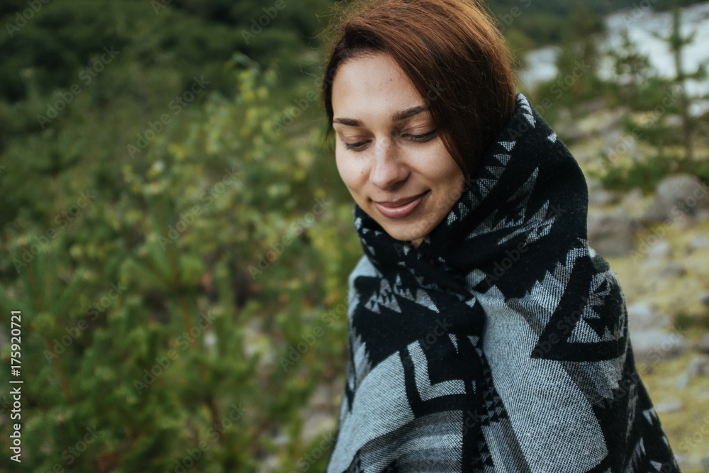 A young smiling woman eyes closed in the mountains A young smiling woman eyes closed in the mountains