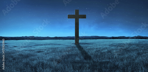 Photography Christian cross in the middle of meadow