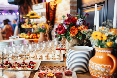 Wallpaper Mural Colorful bouquet made of field flowers stands in the middle of dinner table Torontodigital.ca