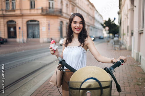 Portrait of beautiful young woman enjoying time on bicycle © NDABCREATIVITY
