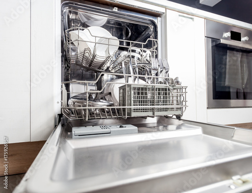 Clean dishes in dishwasher machine after washing