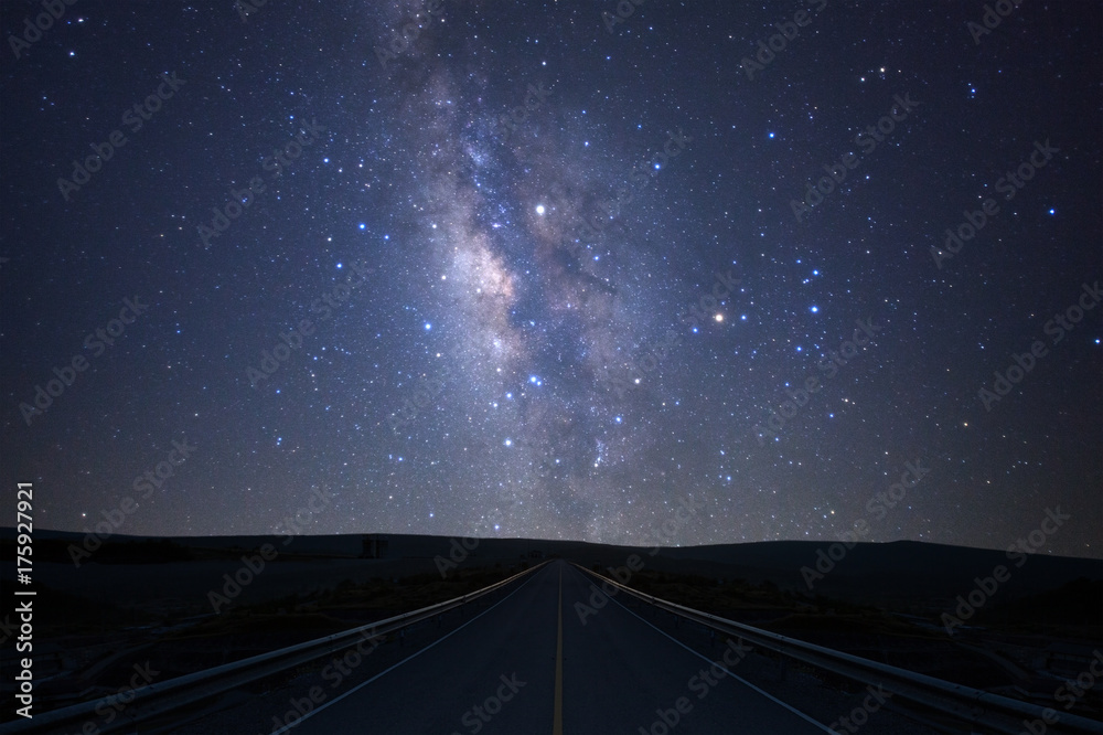 Naklejka premium The milky way galaxy over the road with stars and space dust in the universe