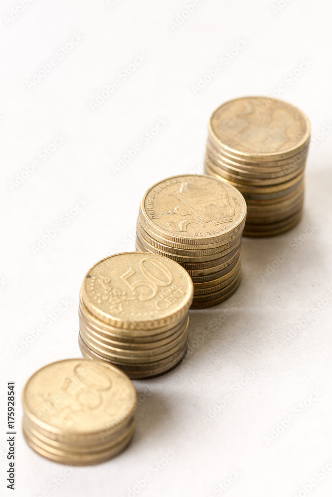 Steps of metal money coins isolated above white background Steps of metal money coins isolated above white background