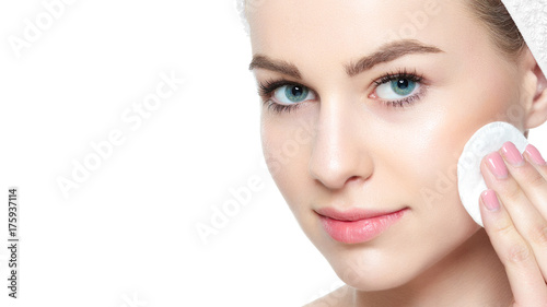 Quadro em tela Attractive young blond woman with towel in her hair removing make up