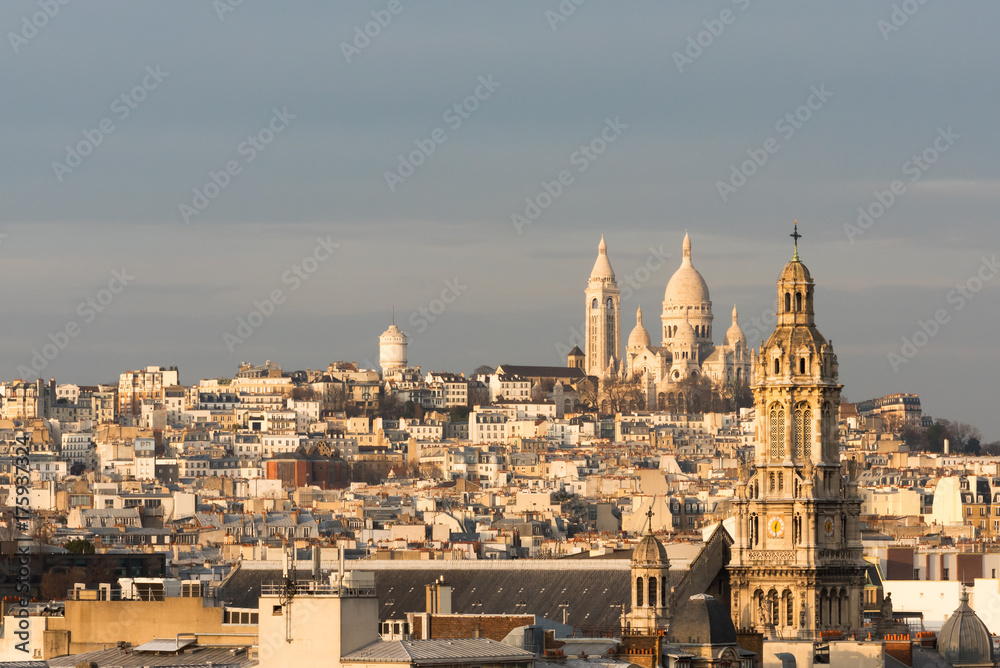 Trinity church and Montmartre at dusk in Paris, France