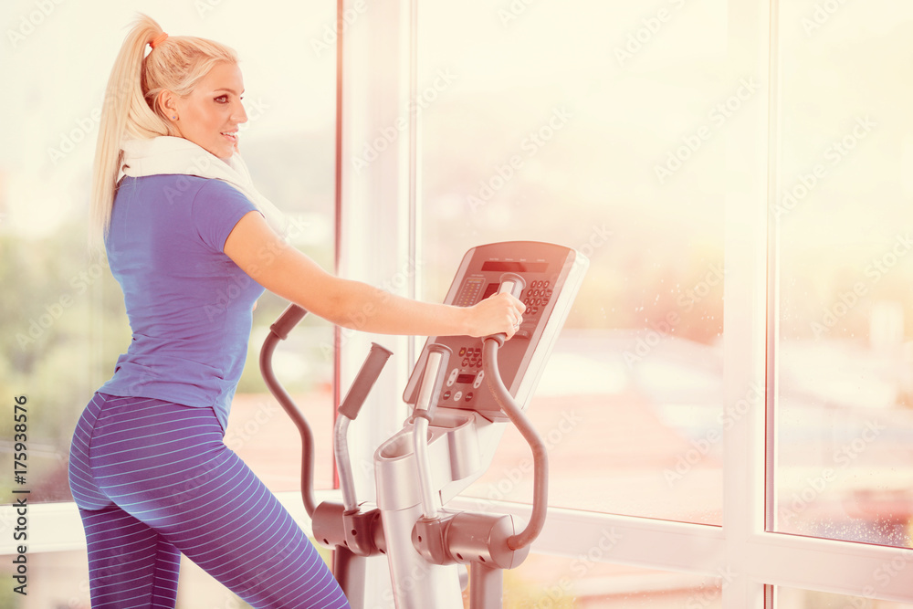 Fitness woman running on treadmill