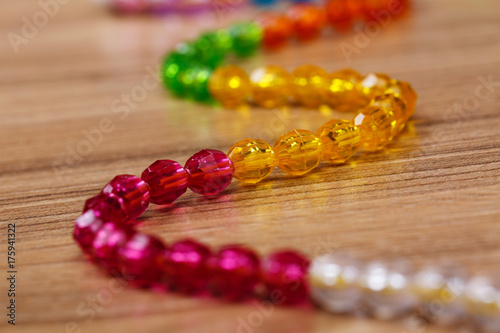 snake of colored beads on a wooden background