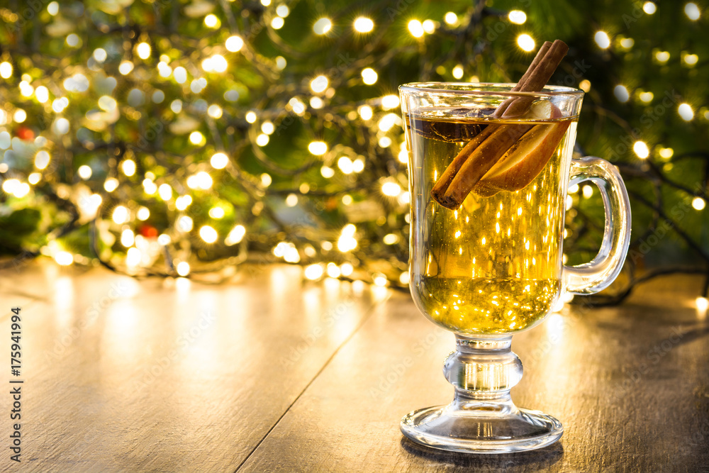 mulled cider in glass, ornaments and christmas light on wooden table.Copyspace
mulled cider in glass, ornaments and christmas light on wooden table.Copyspace