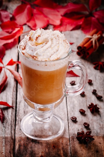 pumpkin latte with whipped cream in a glass jar