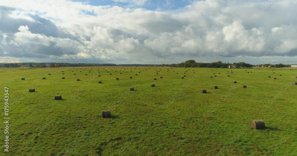 Aerial view of amazing summer landscape. Fields and meadows with baley rolls from above. Aerial view of amazing summer landscape. Fields and meadows with baley rolls from above.