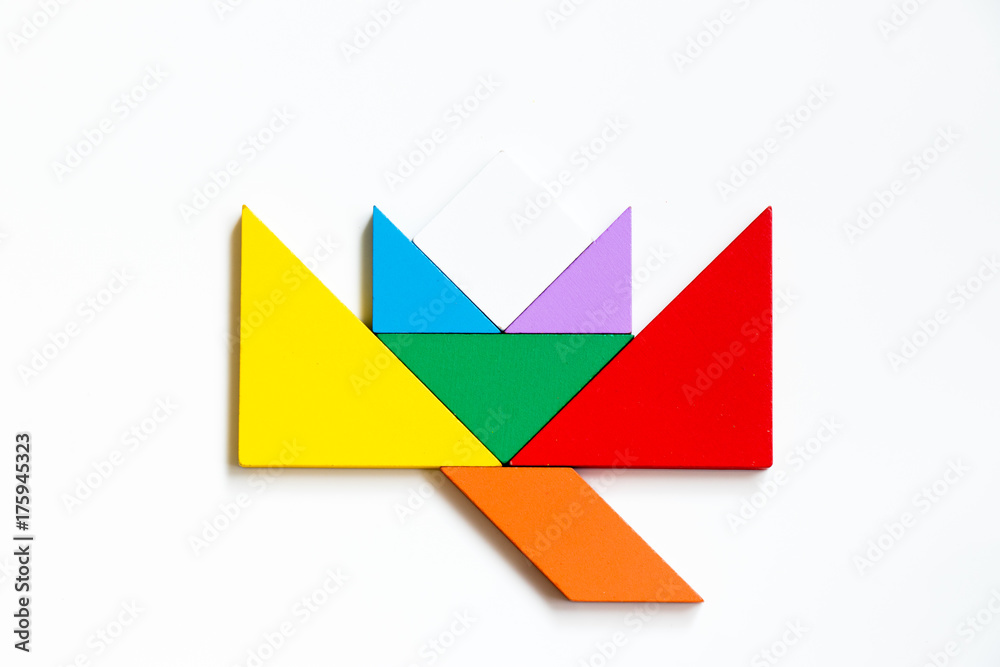 Color wood tangram puzzle in blooming flower shape on white background Color wood tangram puzzle in blooming flower shape on white background