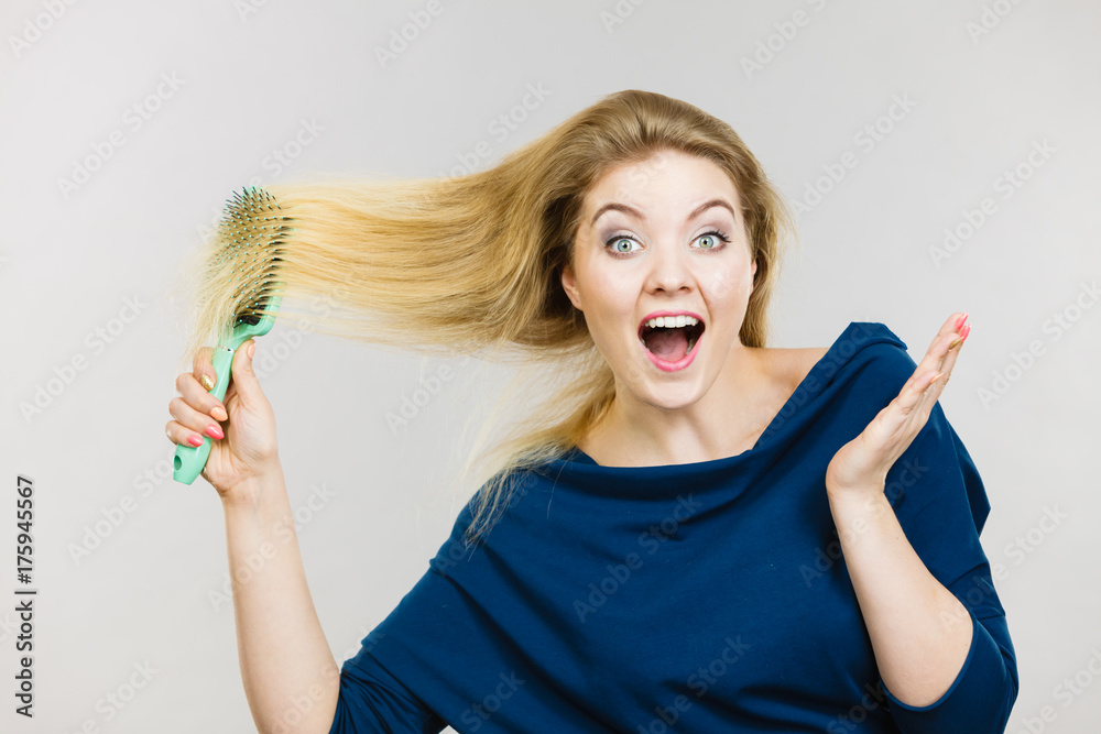 Woman brushing her long hair with brush Stock Photo | Adobe Stock