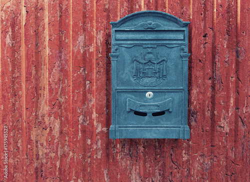 Nostalgic Mailbox on Grungy Red Wall