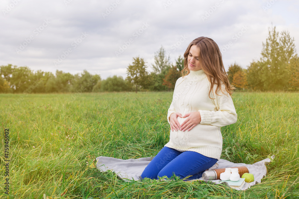 Pregnant woman walking in park sunny summer outdoor mother touching tummy writing diary notebook Pregnant woman walking in park sunny summer outdoor mother touching tummy writing diary notebook