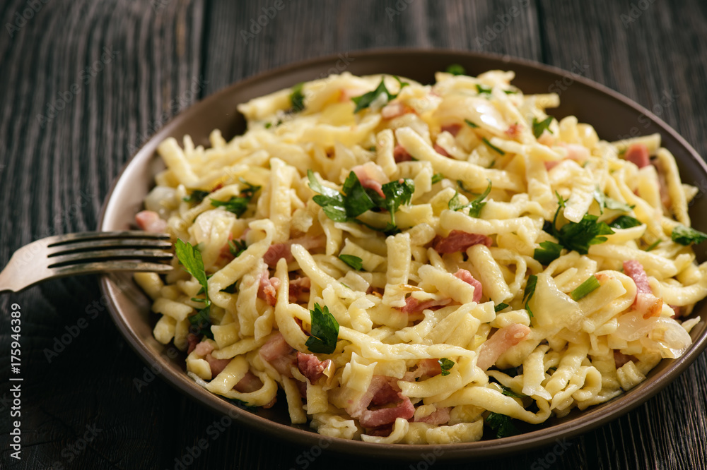 Spaetzle with bacon and onion, german style cuisine. Spaetzle with bacon and onion, german style cuisine.