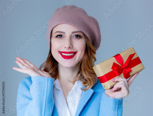 woman in beret with Christmas gift