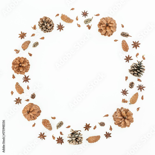 Christmas or New Year round frame with pine cones on white background. Flat lay, top view.