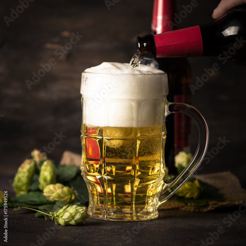 Pouring beer into the glass.