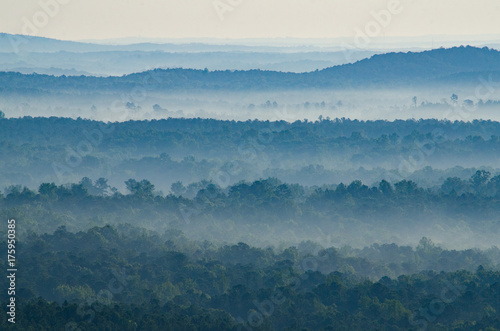 Fog flows through the valleys and hills below a scenic overlook in the Talladega National Forest in Alabama, USA