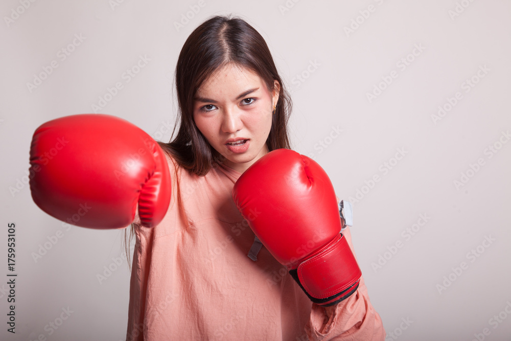 Young Asian woman with red boxing gloves. Young Asian woman with red boxing gloves.