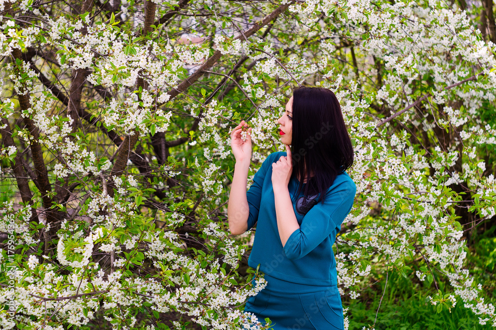 Young beautiful woman in spring blossoming garden Young beautiful woman in spring blossoming garden