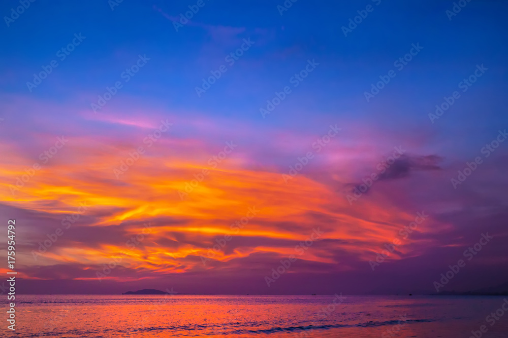 Purple sunset in Sanya, Hainan, China. Colorful madness from the clouds, merging with the sea.