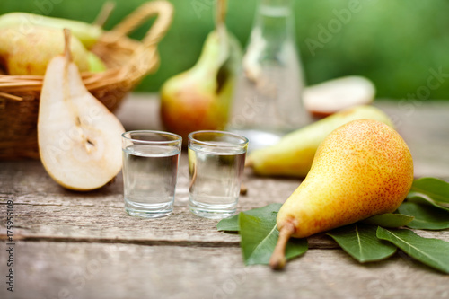 Fototapeta Pears and shot glass with pear brandy