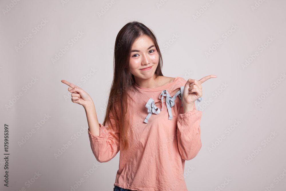 Young Asian woman point to left and right. Young Asian woman point to left and right.