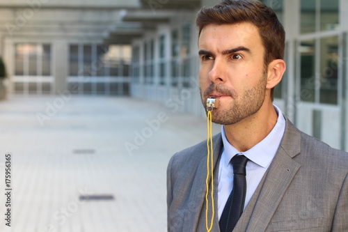 Photography Stern man blowing the whistle in office space