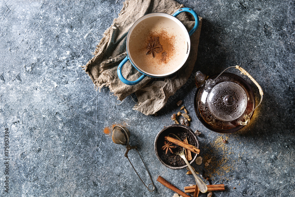 Vintage blue pot of traditional indian masala chai tea with ingredients ...