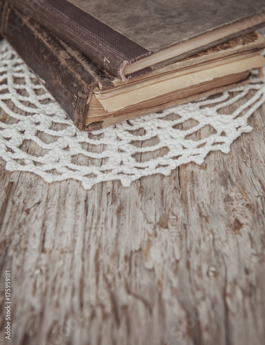 Vintage old books and lace fabric on the old wood