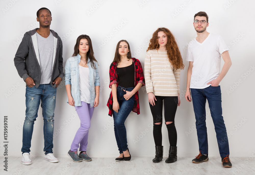 Group of diverse students standing in line indoors Group of diverse students standing in line indoors