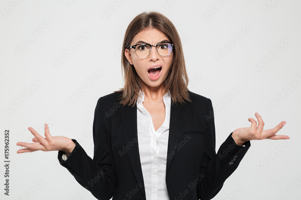 Portrait of a puzzled young businesswoman in suit Portrait of a puzzled young businesswoman in suit