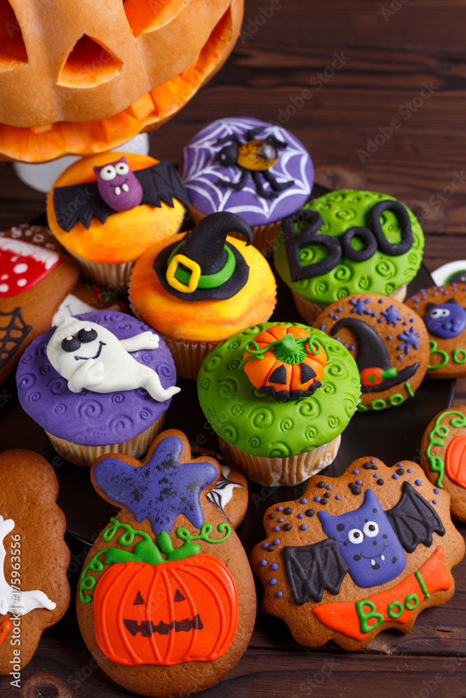 Halloween homemade gingerbread cookies and cupcakes background