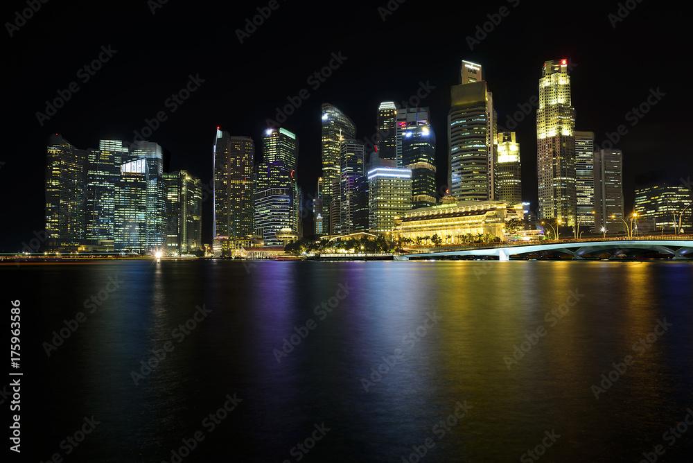 Cityscape with long exposure black sky at night Marina Bay Sands in Singapore.