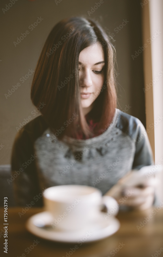 young woman sitting in a coffee shop young woman sitting in a coffee shop