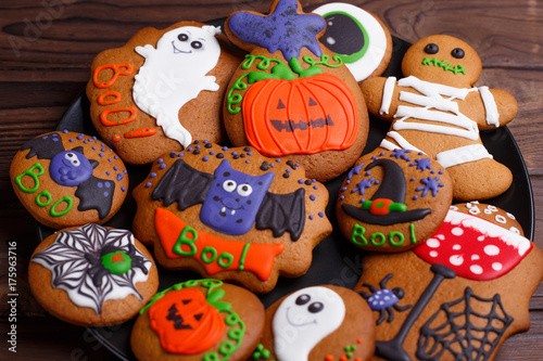 Delicious Halloween treat for dessert: fresh homemade halloween gingerbread cookies on the plate, close up