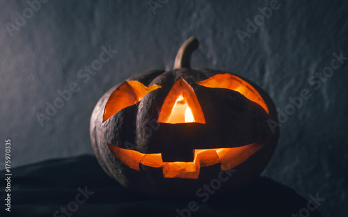 halloween pumpkin head with candle light in darkness background