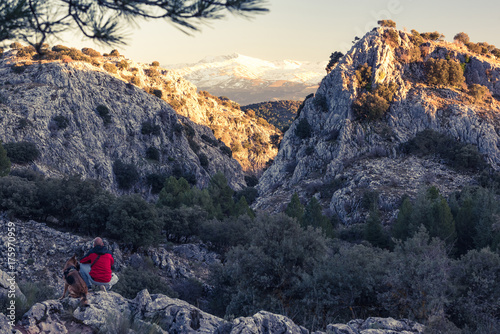 Hikker with bellowed dog in high mountains