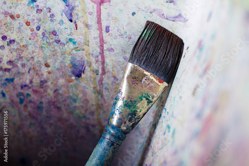 Paint brush in an artist's paint splattered sink