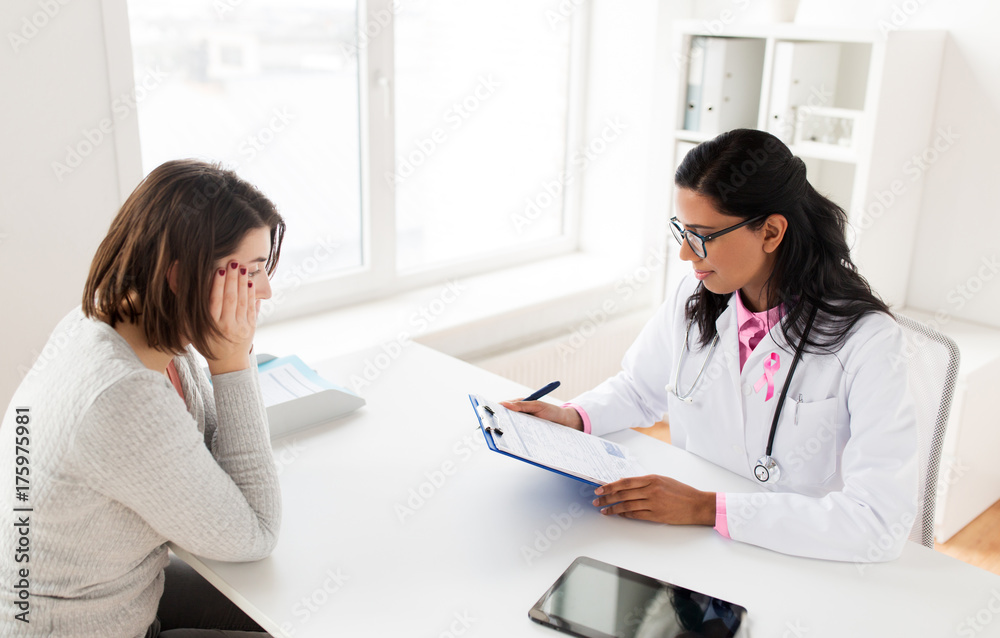 doctor with pink awareness ribbon and patient doctor with pink awareness ribbon and patient
